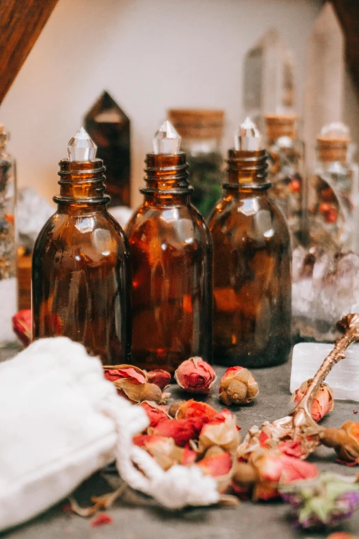 several glass bottles filled with different types of flowers