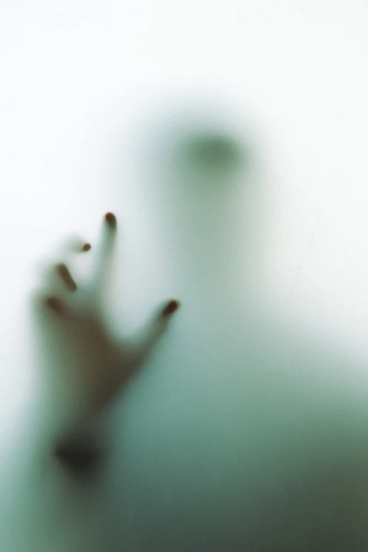 a blurred image of hands reaching up at a person's hand