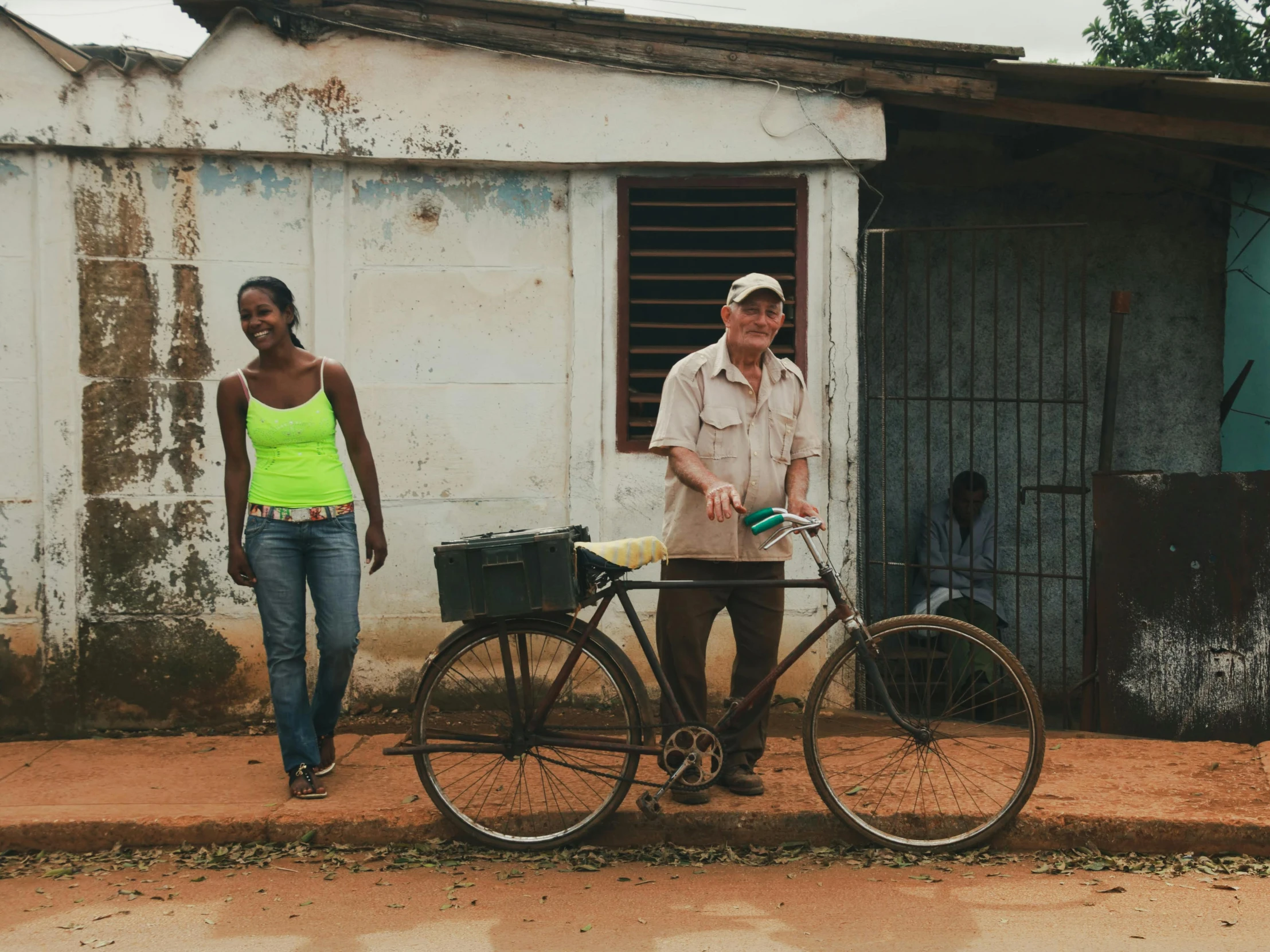 two people are standing outside with their bikes