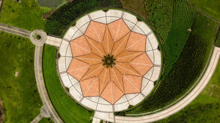 an aerial po of a park with a large brown umbrella