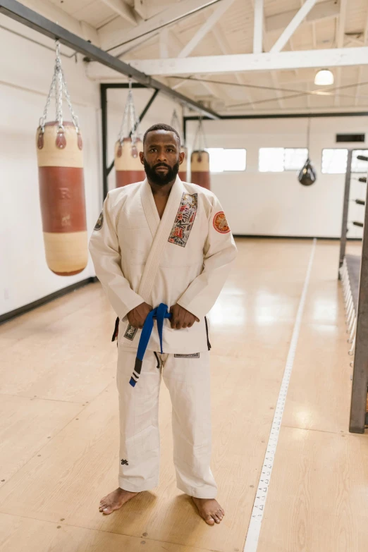 a man wearing a white karate uniform posing for the camera