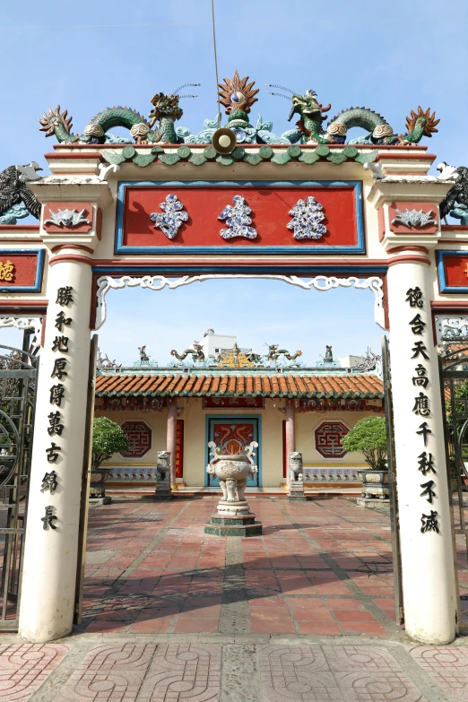a large arch made of wood and decorated with asian decorations