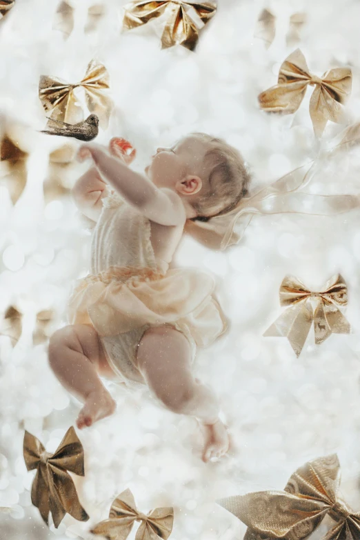 an altered pograph of a baby playing with some decorations