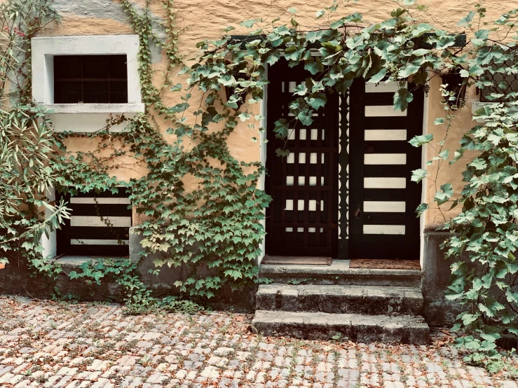 a building with a large door and a lot of plants