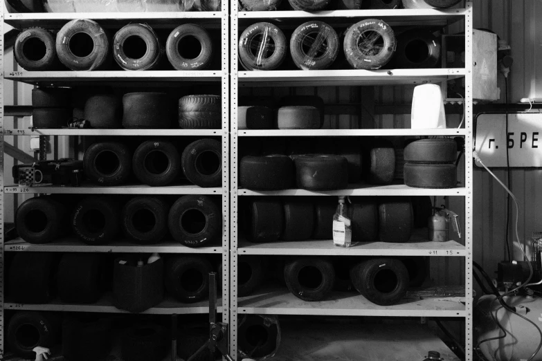 a large shelf of various tires on shelves