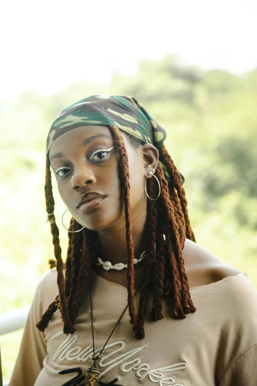 woman with dreadlocks stares into the camera