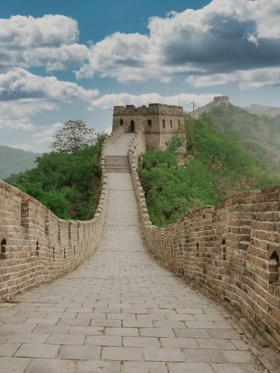 a stone walkway leads up to the great wall of china