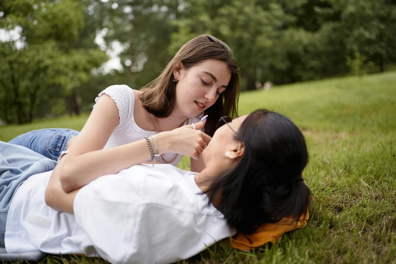 two girls with toothbrushes in their mouths on the ground