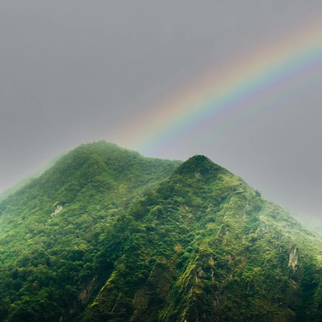 a mountain with a rainbow coming out of the top