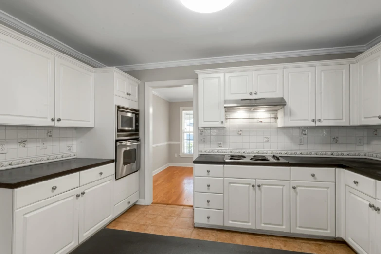 a very large and clean kitchen with all white appliances