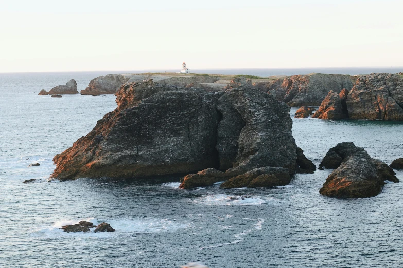 a large rock sticking out of the water