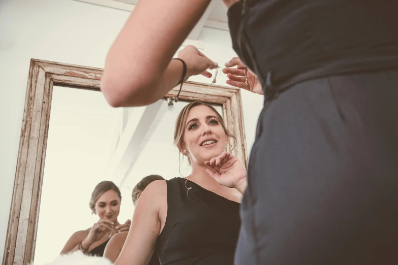 a young woman putting her hand in the face of her other person