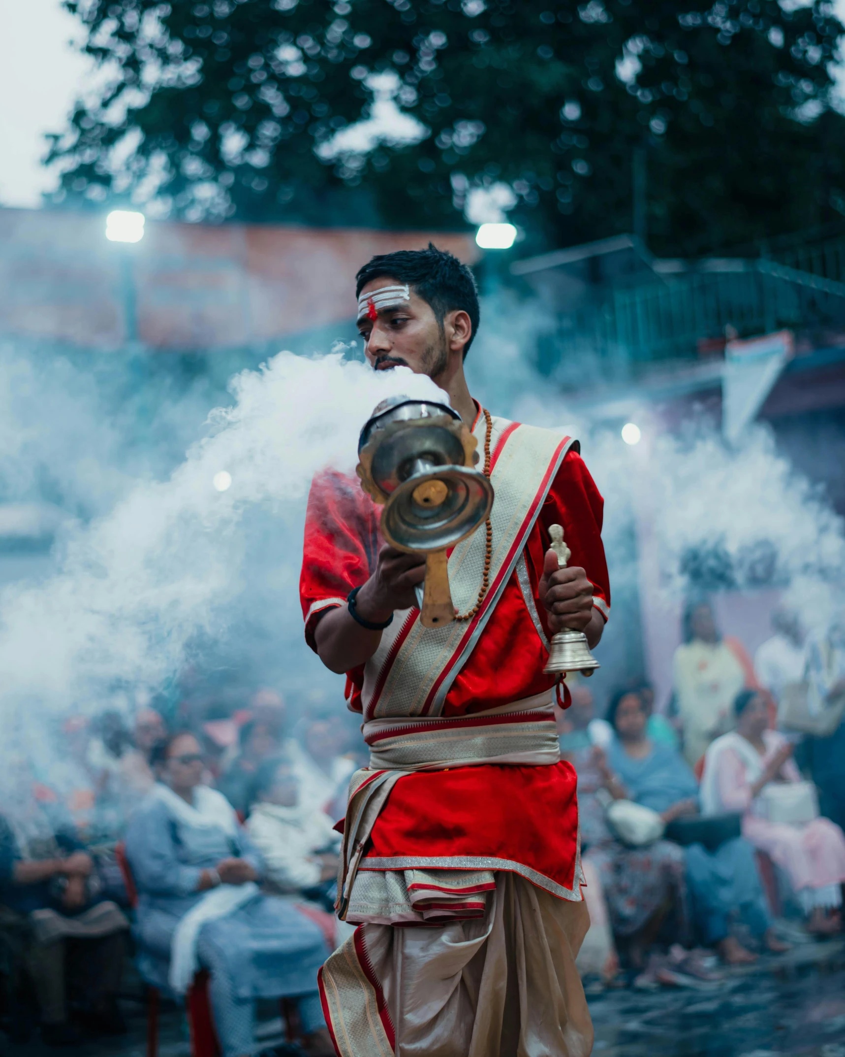 man in costume standing holding a pot with a smoke pouring out of it