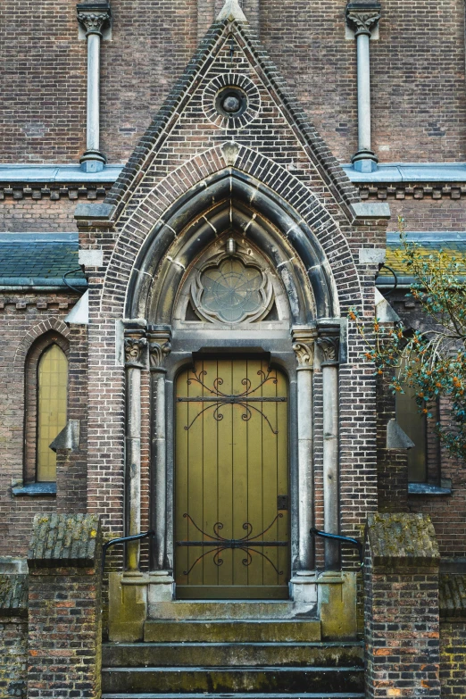 the door to an old building has a stone wall and a metal gate