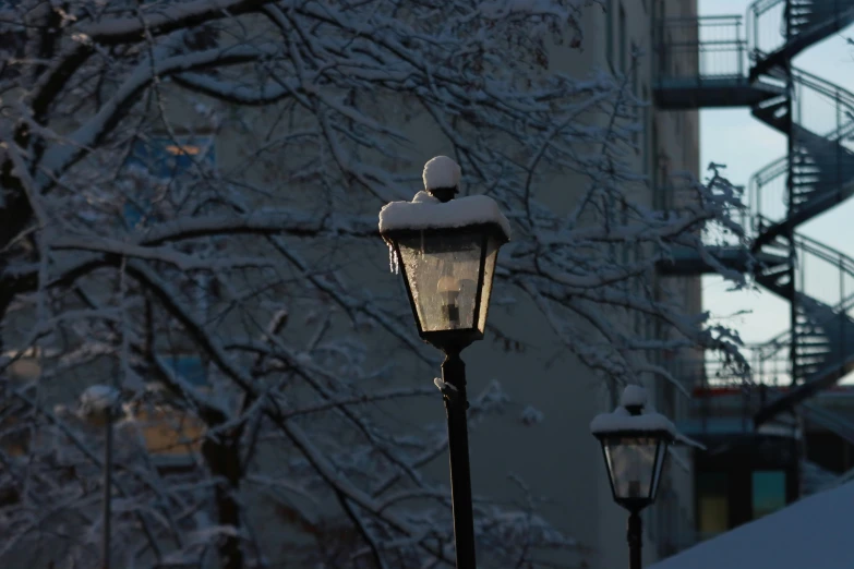 a light pole with a lamp and snow on it