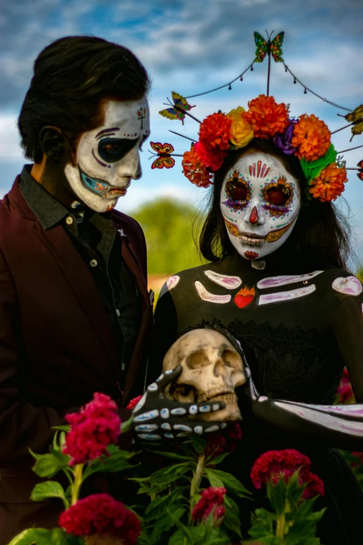 a man and a woman all painted skull and flowers