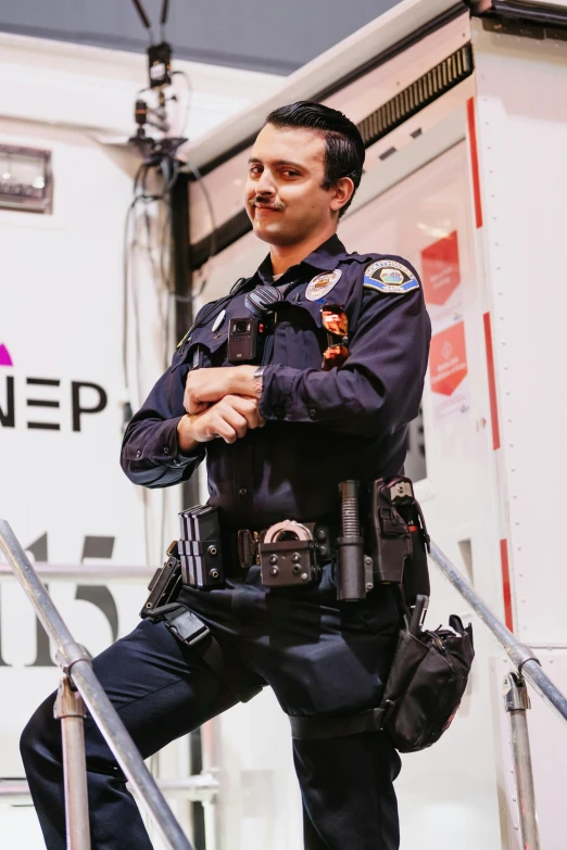 an uniformed police officer on the steps of a truck