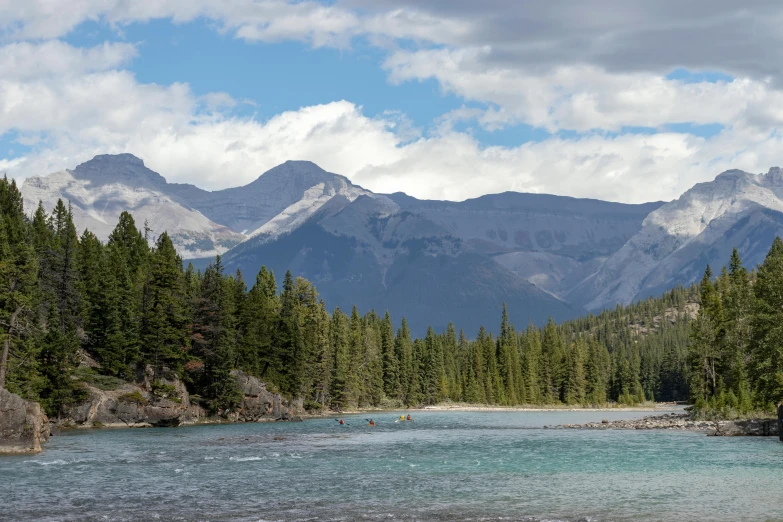 the view of a large mountain range is shown from the river