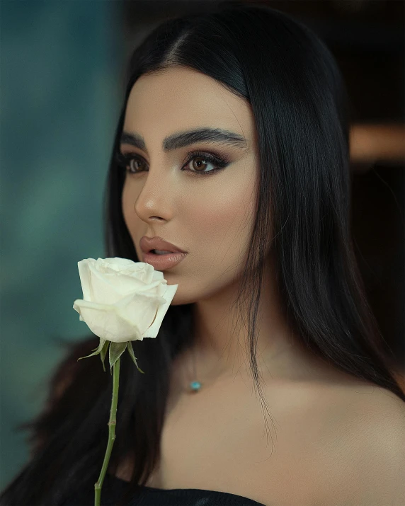 the woman is posing with a white rose in her hand