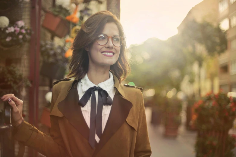 a woman standing on a street with a coat on