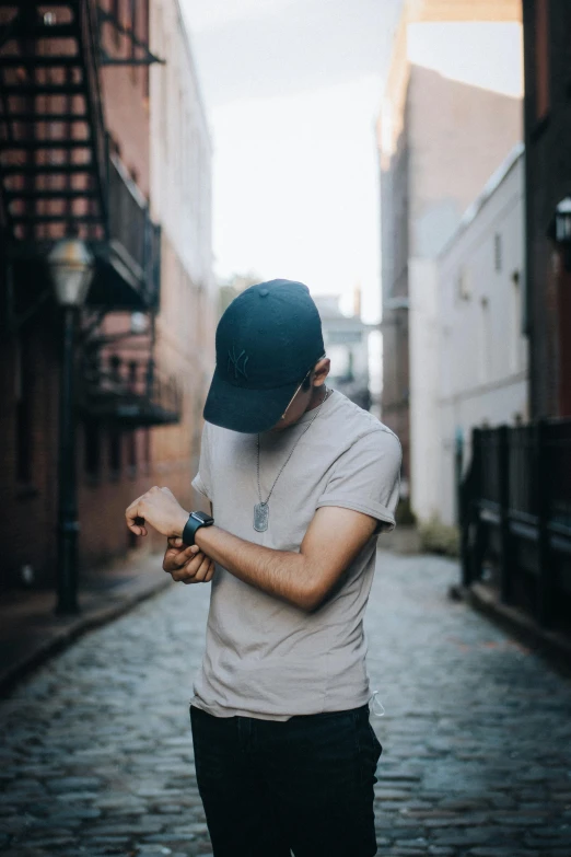 a man in a cap looking down a brick road