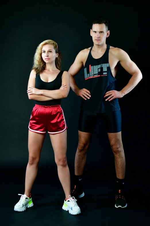 a man and woman pose for the camera, their arms around each other