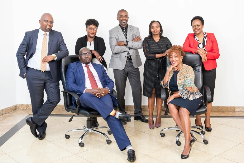 an african american group in office attire posing for a po