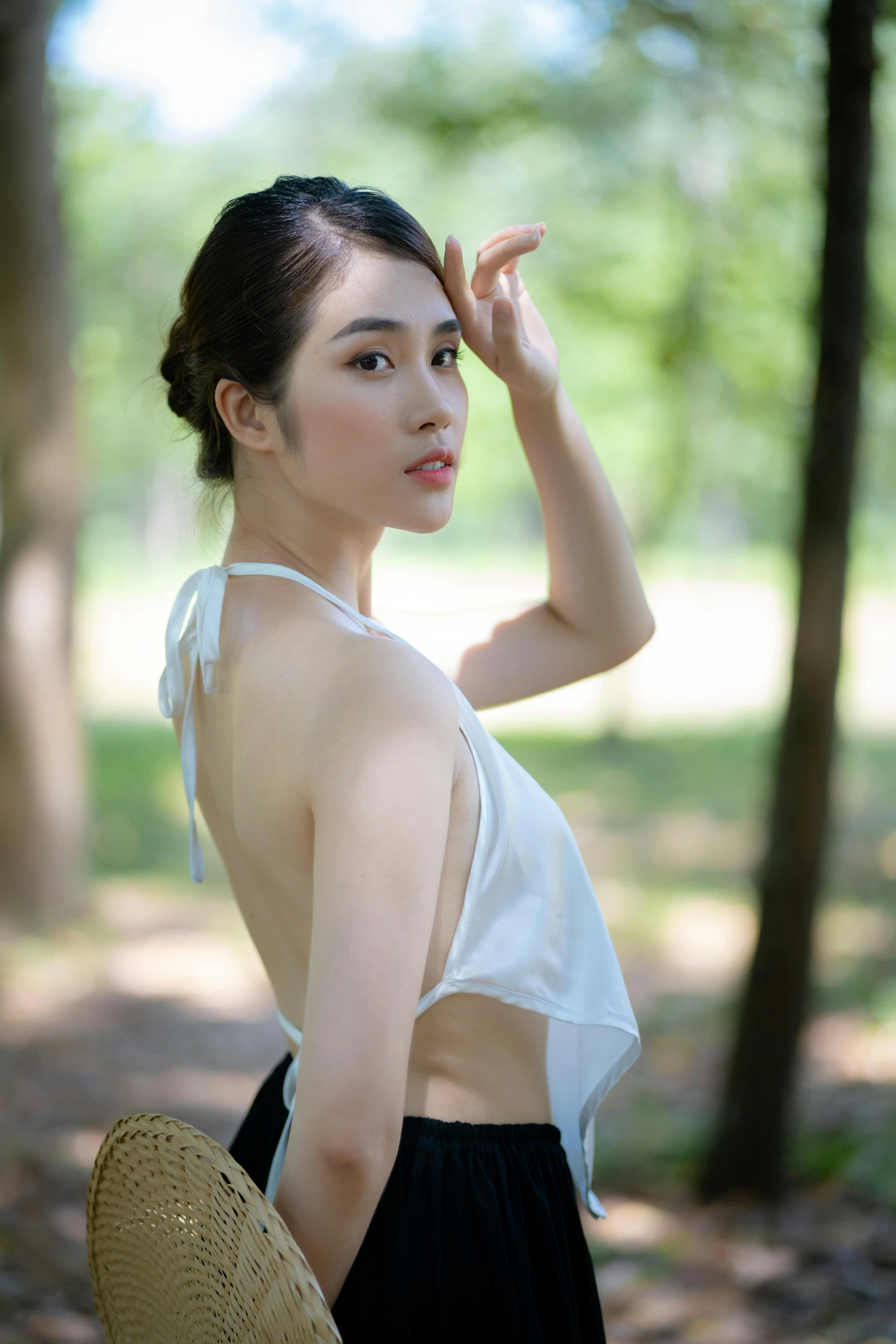 a beautiful young lady standing in the woods