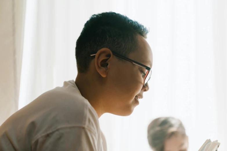 a  with glasses is reading a book