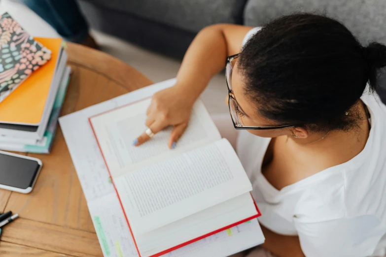 a woman at a table reading a book