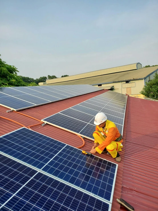 a man working on a rooftop with solar panels