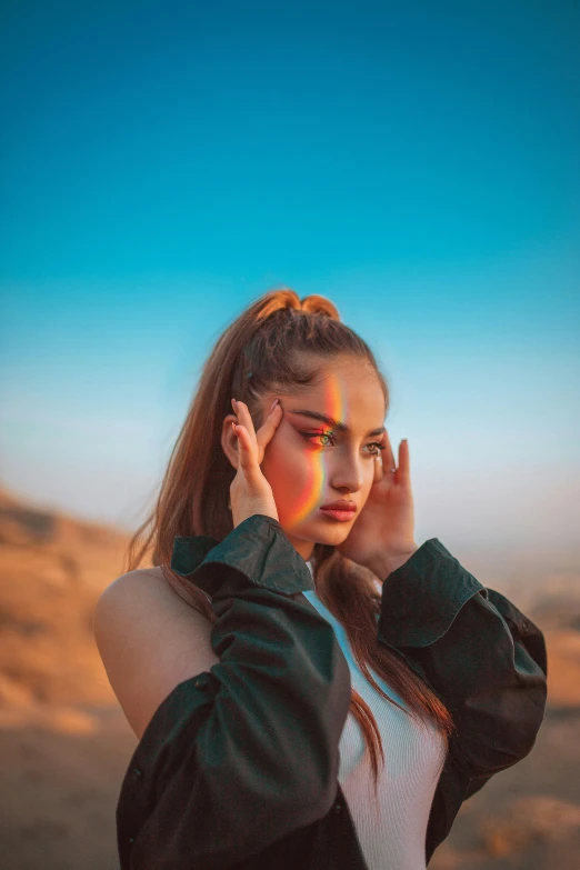 a woman wearing black is standing in the middle of a desert