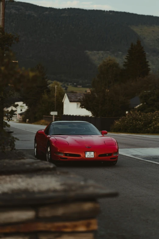 a red sports car on a mountain road