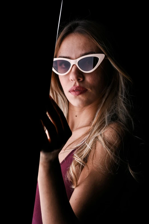 woman in sun glasses on dark background