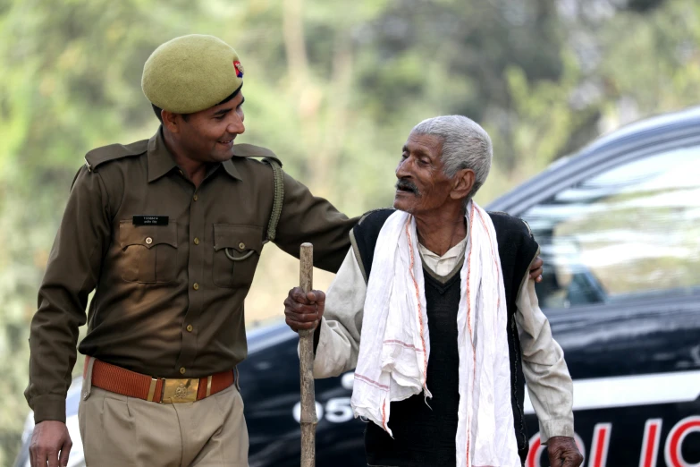 an old man in uniform and a young gentleman standing next to each other