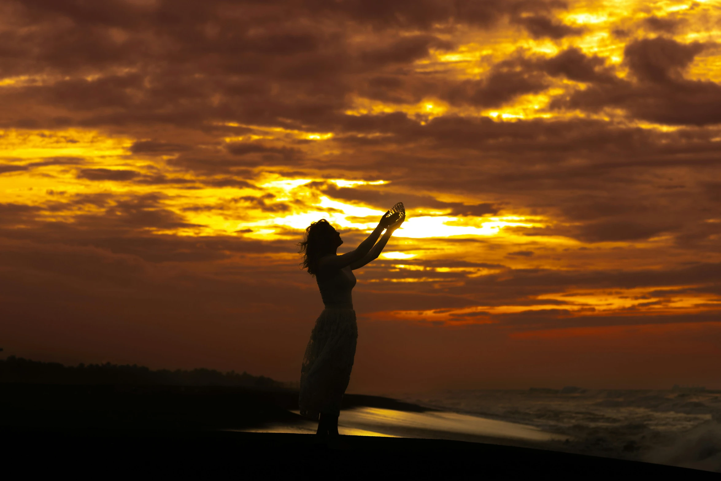 the woman is enjoying her time with the sky in sunset