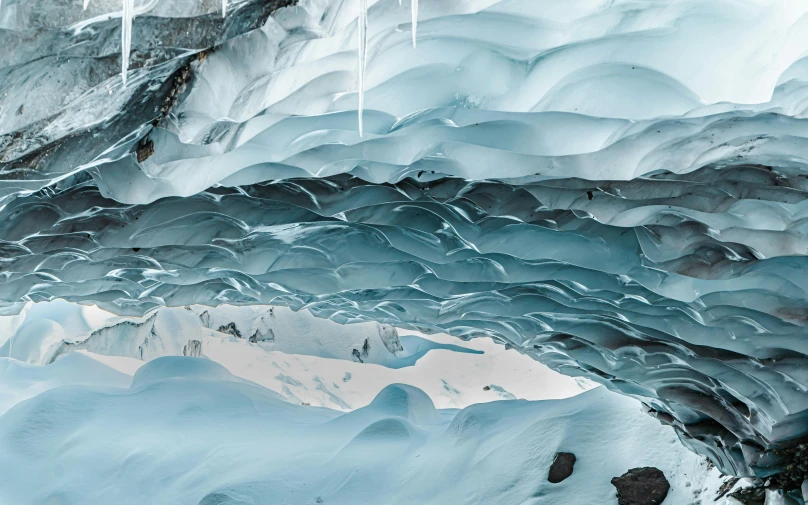 the glacier walls are covered with ice and snow