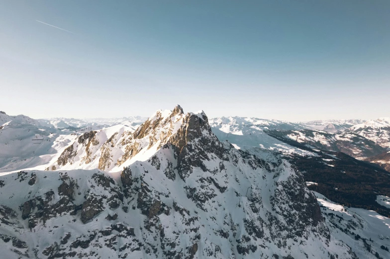 snow - covered mountains sit above the surrounding valleys