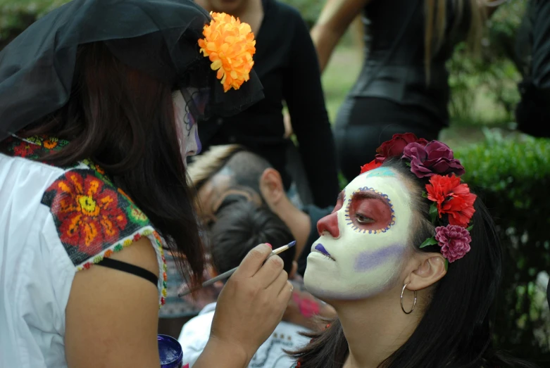 a woman is getting her make up done at an event