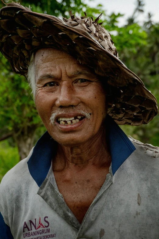 a man wearing a hat with silver metal teeth