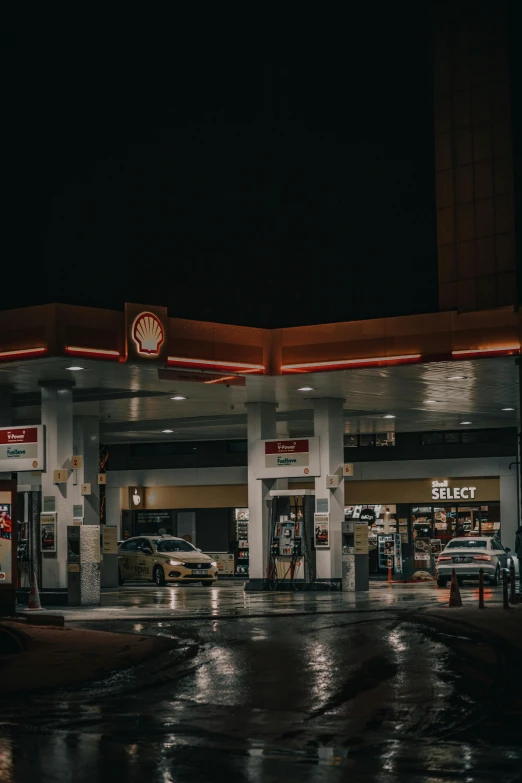the lights shine on an empty gas station at night