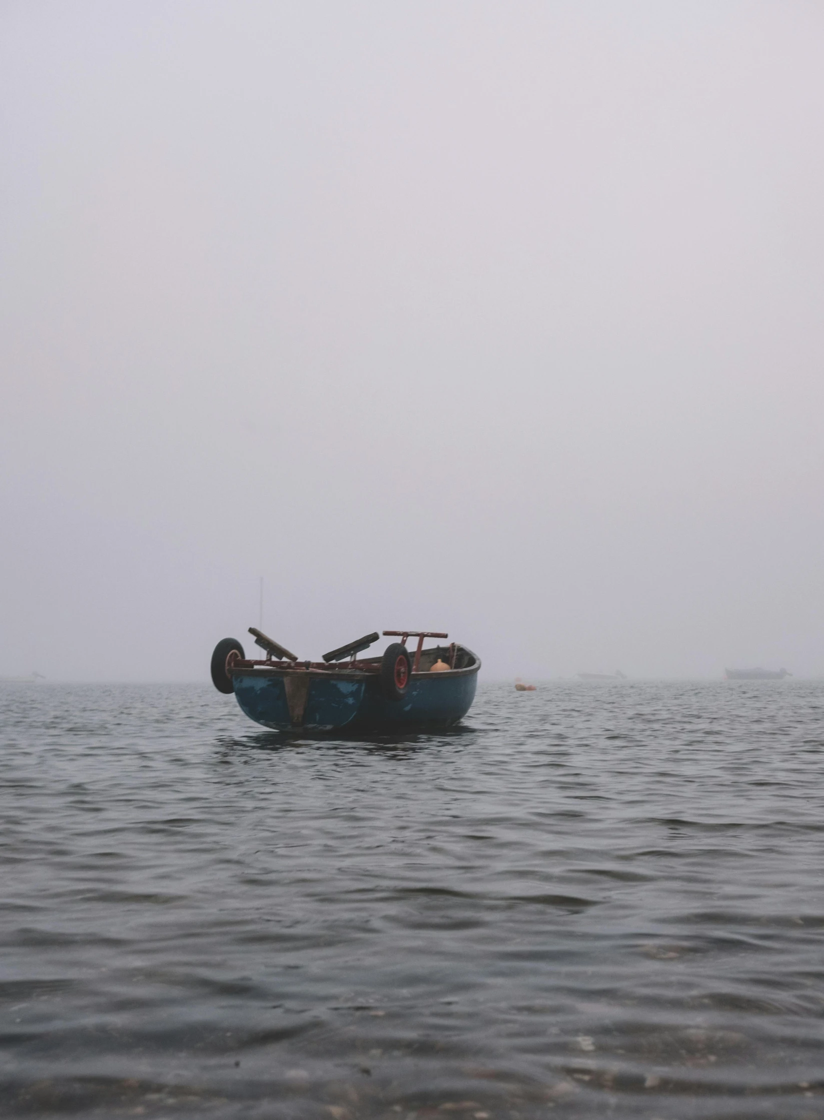 a small blue boat out on the water