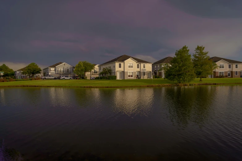 a house is reflected in a body of water