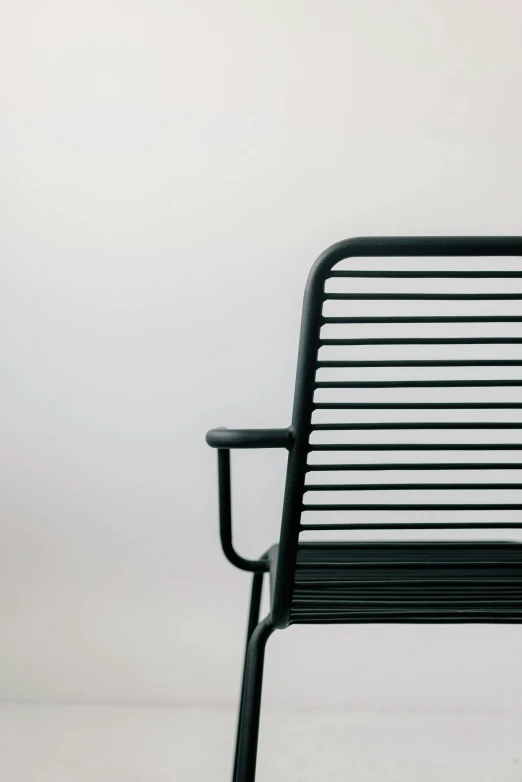 a black metal chair in front of white background