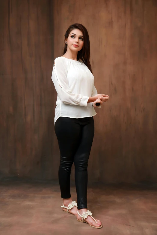 a woman posing in a studio for a picture