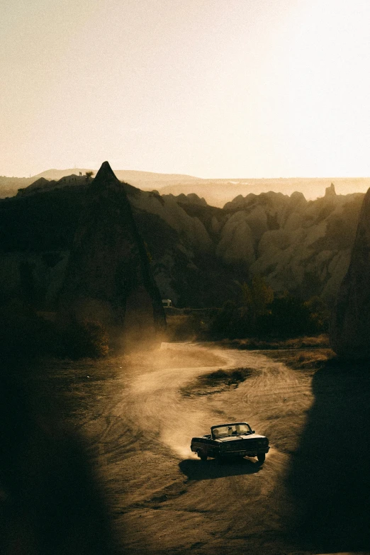 a car is driving down a road in the country