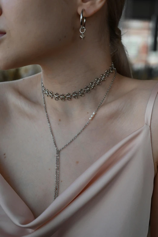 a women in a pink dress with some jewelry