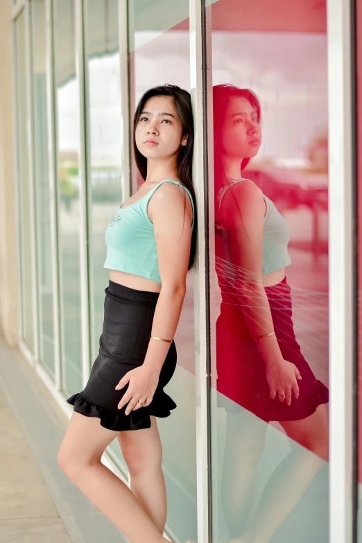 a woman leaning against the glass with her leg up