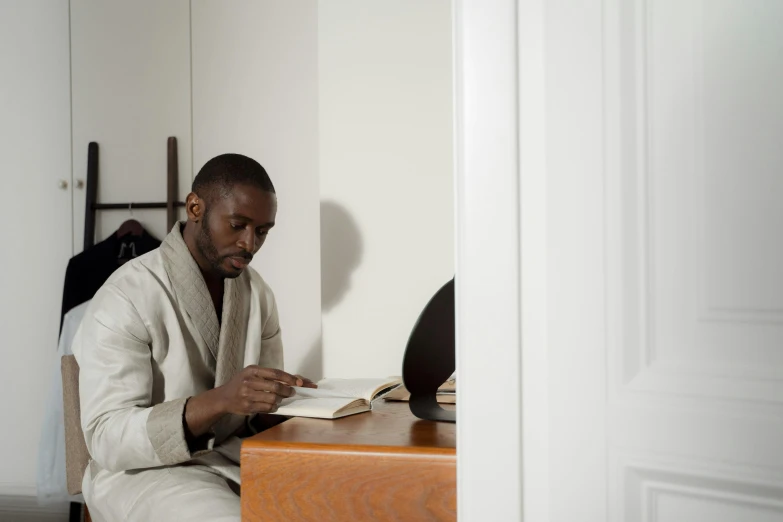 a man is sitting down with his book