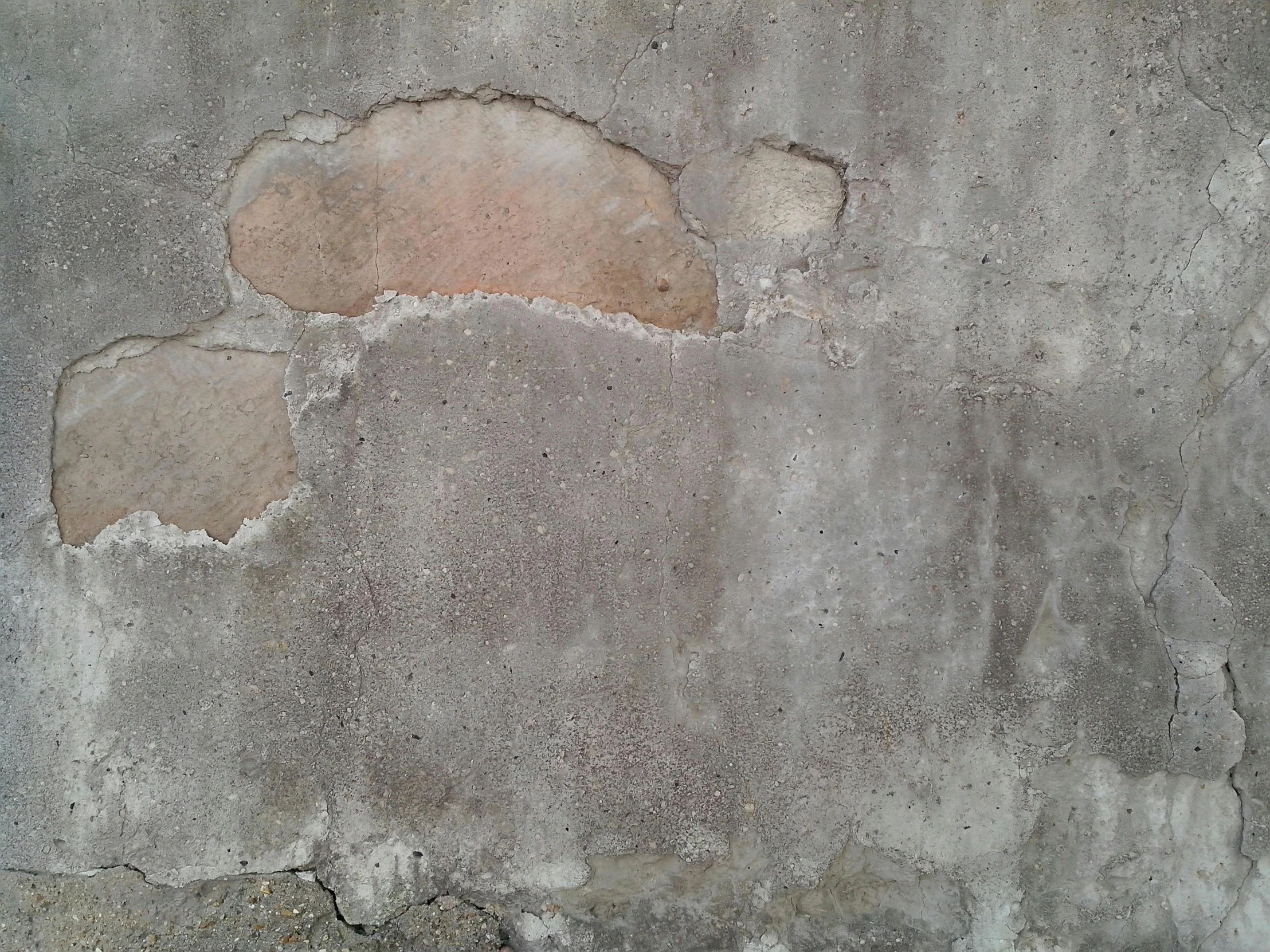 an old ed concrete wall has holes in it